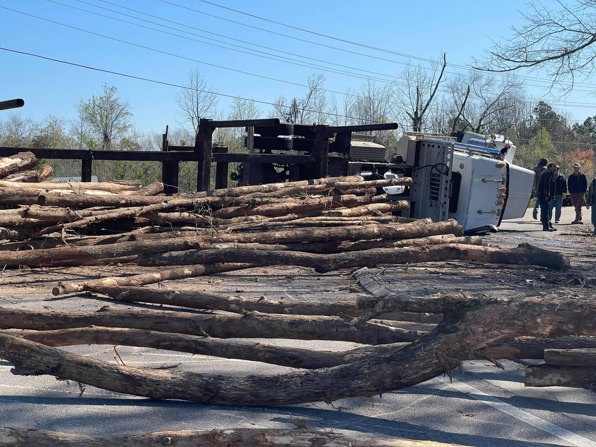 Log truck overturns at corner of Highway 15 and Industrial Park Thursday morning