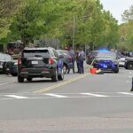 Suspect identified as Tyler Brown shot after opening fire on Cambridge roadway; two injured Suspected roadway gunman with reported criminal history sparks outrage after drivers shot