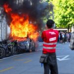 Violent protest in Geneva damages Tesla and UN office during G7 demonstrations Anti-G7 protest turns violent as demonstrators torch Tesla and smash UN office windows