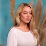 Sydney Sweeney wears gold 'SB' necklace in Syrn campaign; initials match boyfriend Scooter Braun Sydney Sweeney gives subtle nod to boyfriend Scooter Braun in new lingerie campaign