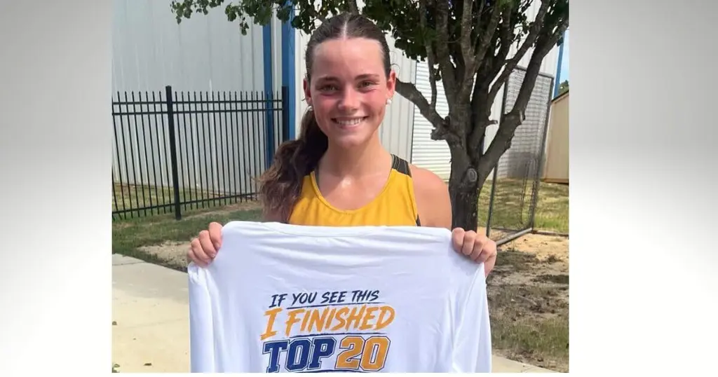 Ripley senior Jenna-Lynne Massengill holds a cross-country top-20 finisher shirt.