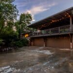 The 5 Best Outdoor Security Flood Lights for Tippah County Homes Rural home with a well-lit driveway at dusk — security flood lights keep farmsteads and driveways visible after dark