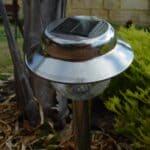 The 5 Best Solar Outdoor Lights for Tippah County Rural Driveways Solar-powered outdoor lamp glowing beside a driveway at dusk