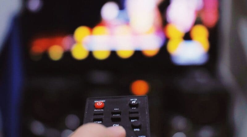Person holding a TV remote while watching television, illustrating the Kirby Carpenter Dateline episode on NBC