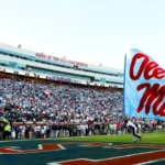 Mississippi News Report — Friday, Oct 30: Ole Miss, Jones, Northwest A person waves a light-blue Ole Miss flag in the end zone at Vaught-Hemingway Stadium, with a packed crowd in the stands behind