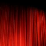 Last Chance for Love Play Set Nov. 7 in Bolivar Red stage curtain under theater lights, illustrating the Last Chance for Love stage production