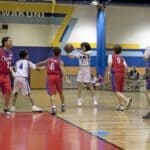 Middleton Basketball Sweeps Hornsby in Road Doubleheader Youth basketball players in red and white uniforms during a gym game, illustrating Middleton basketball