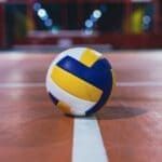 Middleton Volleyball Heads to State Tournament Tuesday High school volleyball players at the net, illustrating the Middleton volleyball state tournament trip