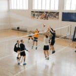 Ripley, Walnut Volleyball Win Playoff Matches, Host Thursday Volleyball players going up for a block at the net in an indoor gym, illustrating the Ripley Walnut volleyball playoffs