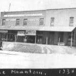 Tippah County Archives Shares 1930s Photos, Seeks Help Tippah County Archives historic photo of a brick store block in Blue Mountain, Mississippi, in 1938, with dry goods signs and the Bank of Blue Mountain