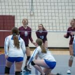 Tippah County Volleyball All-Tournament Team Announced High school girls volleyball players at the net during an indoor match, illustrating the Tippah County volleyball all-tournament team
