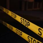 Toone Shooting: Man Charged With First-Degree Murder Yellow police tape at a crime scene, illustrating the Toone shooting investigation in Hardeman County