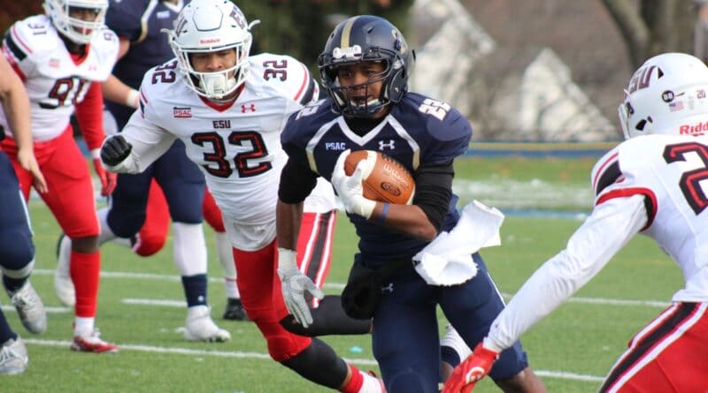 High school football player carrying the ball during a game, illustrating the Walnut homecoming win