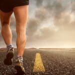 Whiteville Police Captain Runs St. Jude Marathon for Daughter Runner's feet on an asphalt road at sunset, illustrating St. Jude Marathon training